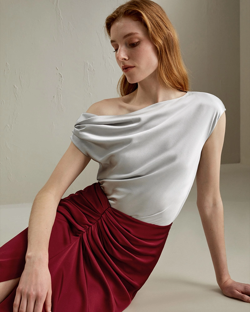 Elegant custom silk off-the-shoulder blouse in ivory, designed by high-end clothing manufacturer in Dongguan, China.