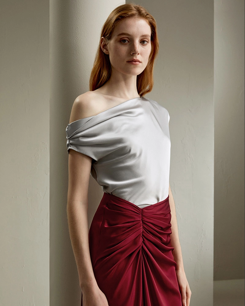 Model wearing custom-made silk off-the-shoulder blouse, tailored by premium Chinese OEM and ODM clothing factory.