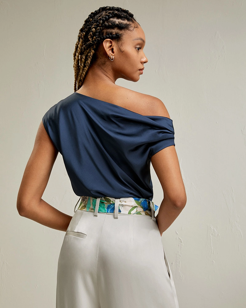 Elegant custom clothes silk off-the-shoulder blouse in ivory, designed by high-end clothing manufacturer in Dongguan, China.