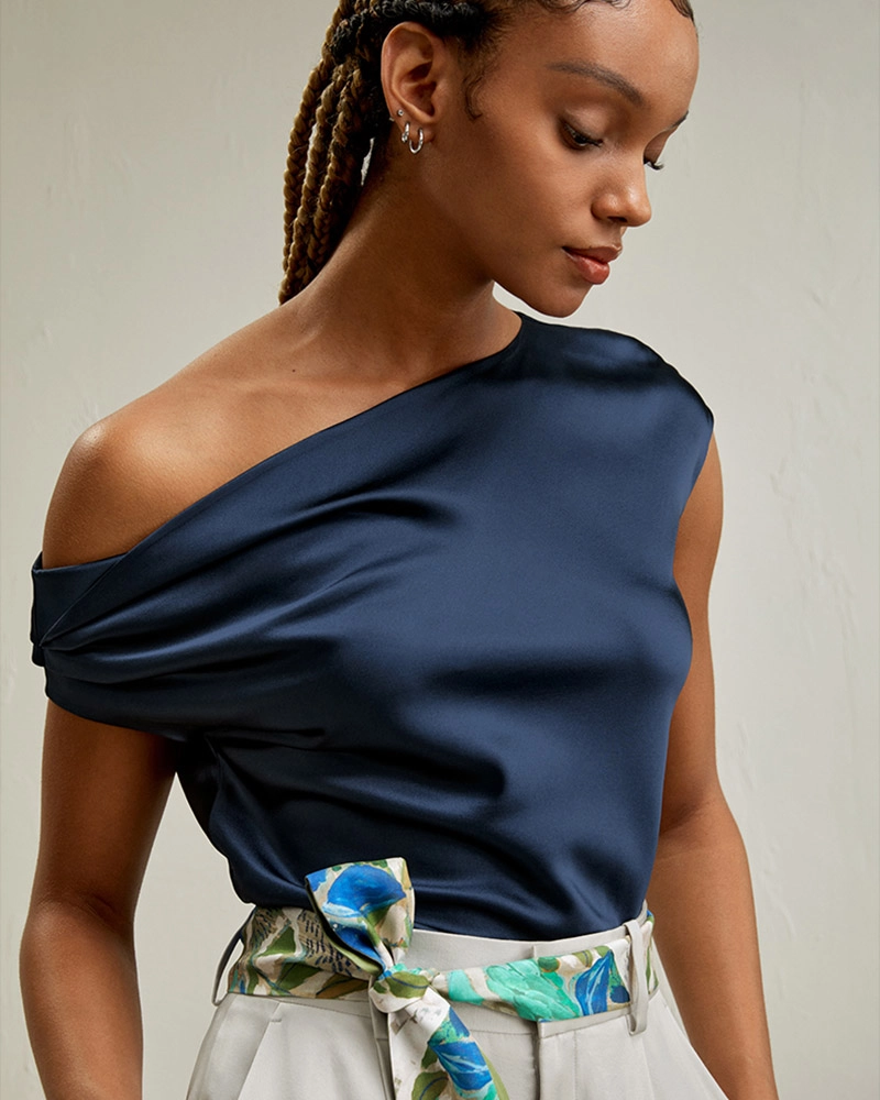 Model wearing custom clothes silk off-the-shoulder blouse, tailored by premium Chinese OEM and ODM clothing factory.